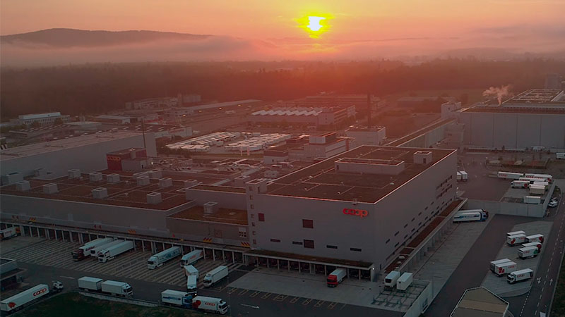 Overview of the Coop distribution center in Switserland with the sun going down