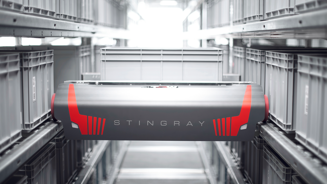 TGW Logistics' Stingray shuttle transporting a tote in an automated storage and retrieval (ASRS) aisle