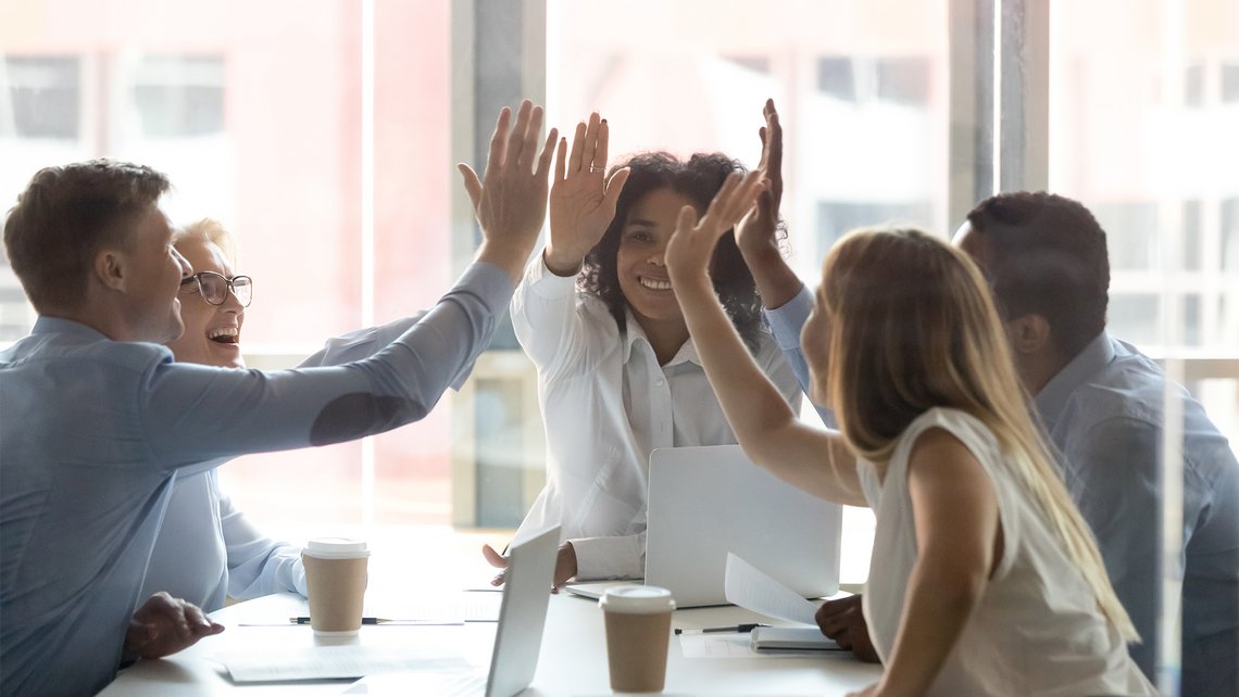 A group of people high-fiving