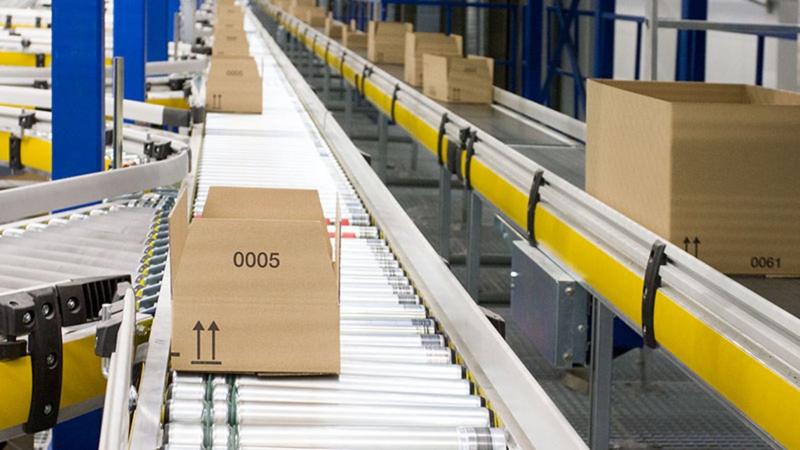 Parcels on a conveyor belt inside a modern logistics center