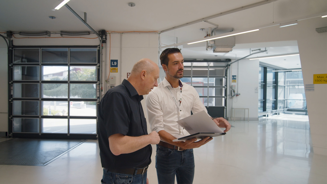 Two men looking over logistics consulting ideas before entering the distribution center floor