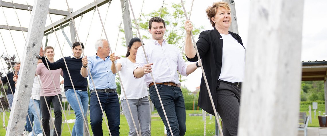 Smiling people on a rope swing