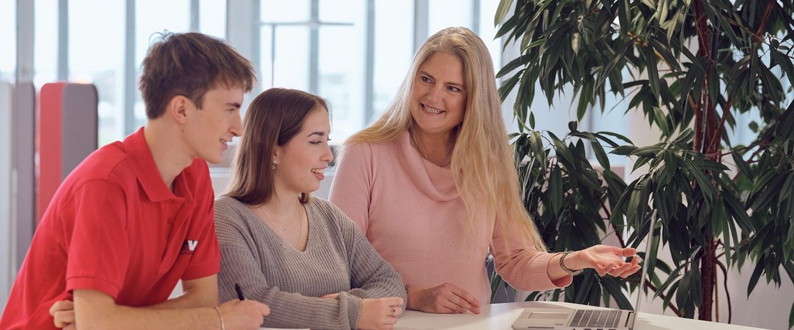 Three TGW Logistics' employees having a conversation during their break