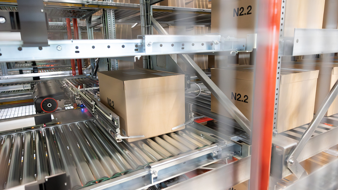 View of a TGW Logistics' Stingray shuttle retrieving a case from one of the shuttle aisles in the Puma distribution center