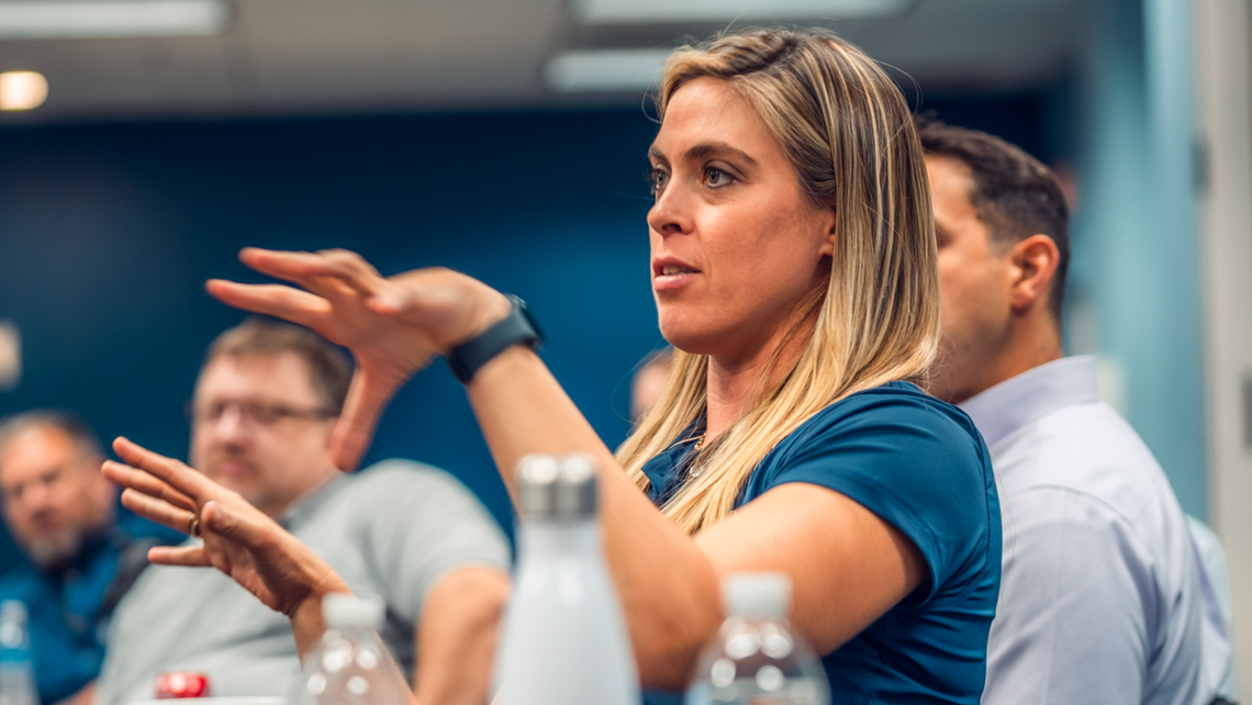 Female attendee of Gap Campfire Talk explaining her thoughts to other attendees