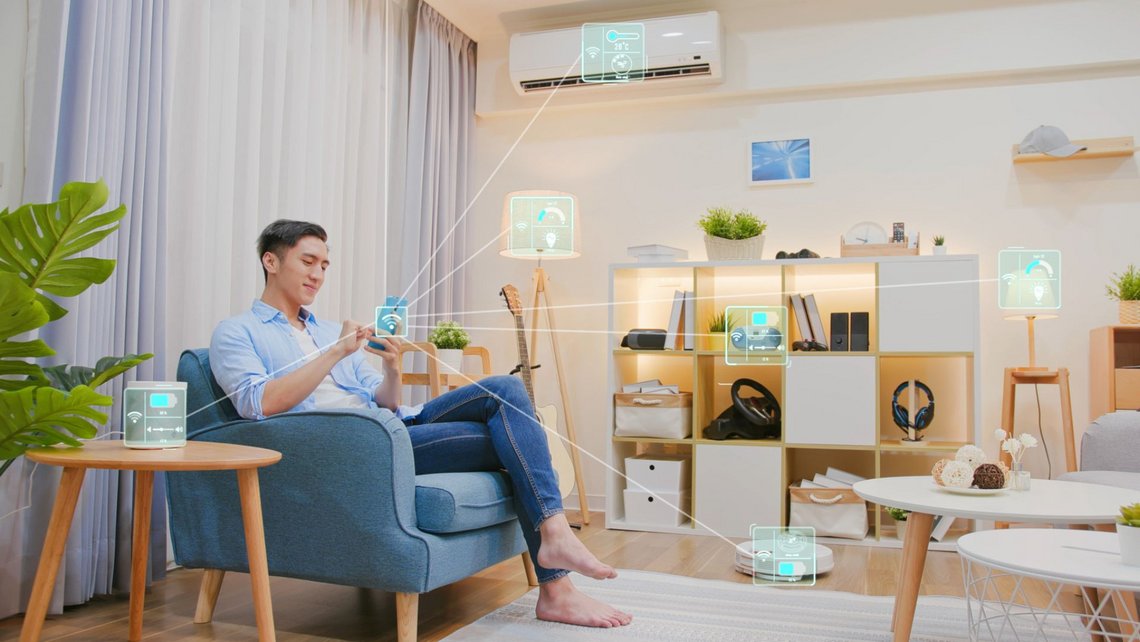 Man sitting inside a modern home with smart appliances