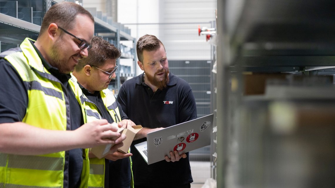 TGW employees performing maintenance inside the Puma distribution center