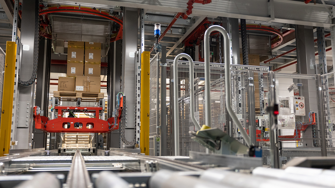 View of a fully automated palletizer in action. TGW Logistics' AutoStax is putting the final cartons on and about to lower the pallet for automatic shrink wrapping.