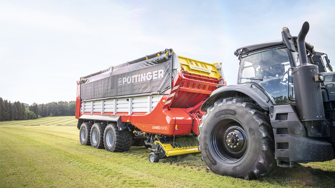 Agricultural appliances out on the field with a tractor pulling another appliance