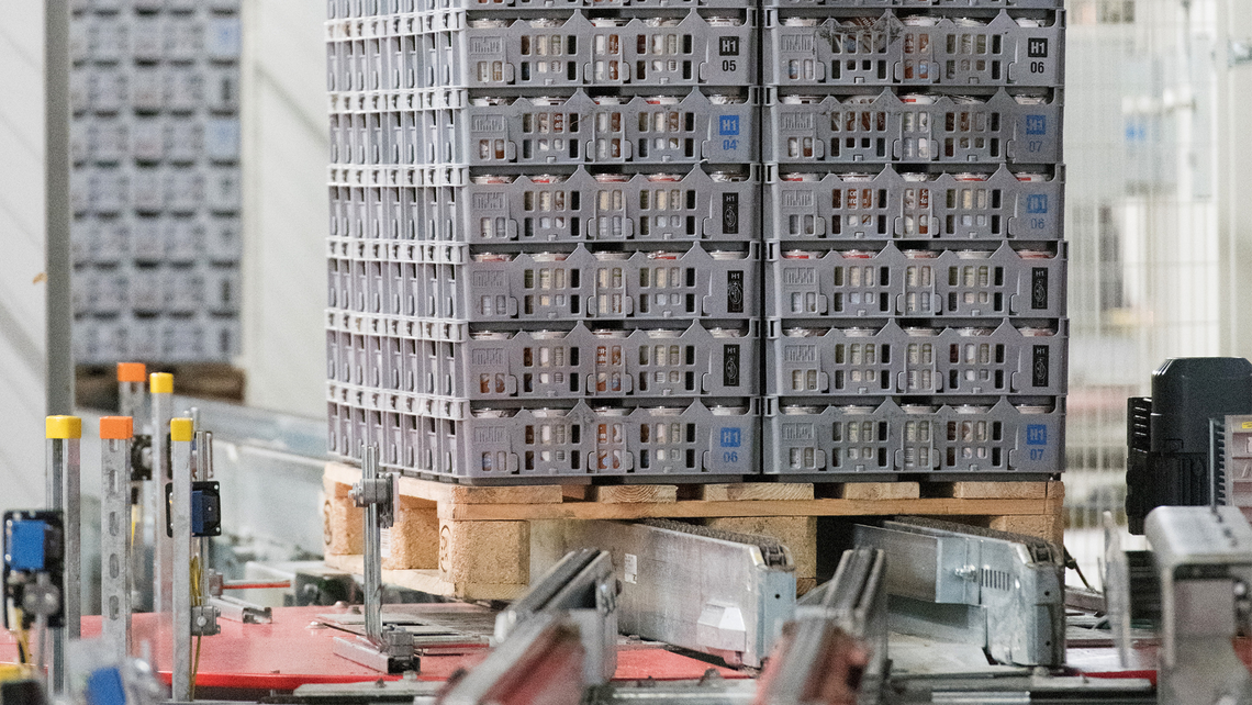 Pallet with totes full of grocery goods on a TGW Logistics conveyor belt systems